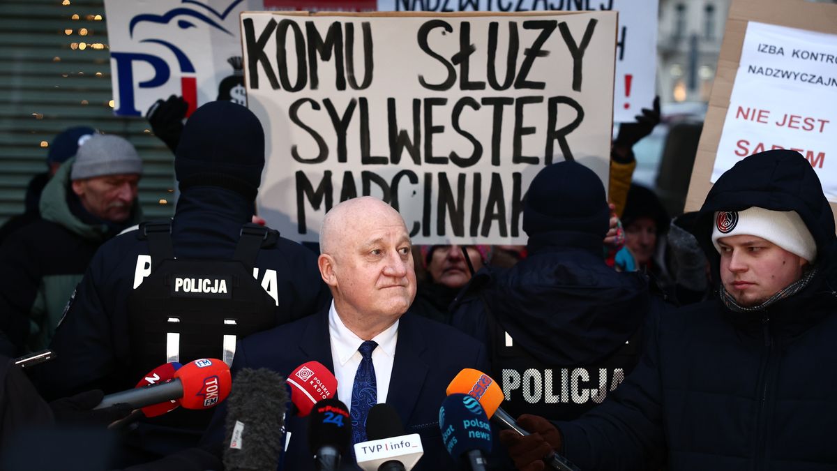 Chairman Sylwester Marciniak speaks to the media after the National Electoral Commission meeting, as people gather to protest near the commision headquarters in Warsaw, Poland on December 30, 2024. (Photo by Jakub Porzycki/NurPhoto via Getty Images)