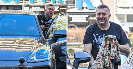 Norbi śle fotoreporterom uśmiechy i pozuje przy porsche wartym prawie 400 tysięcy złotych