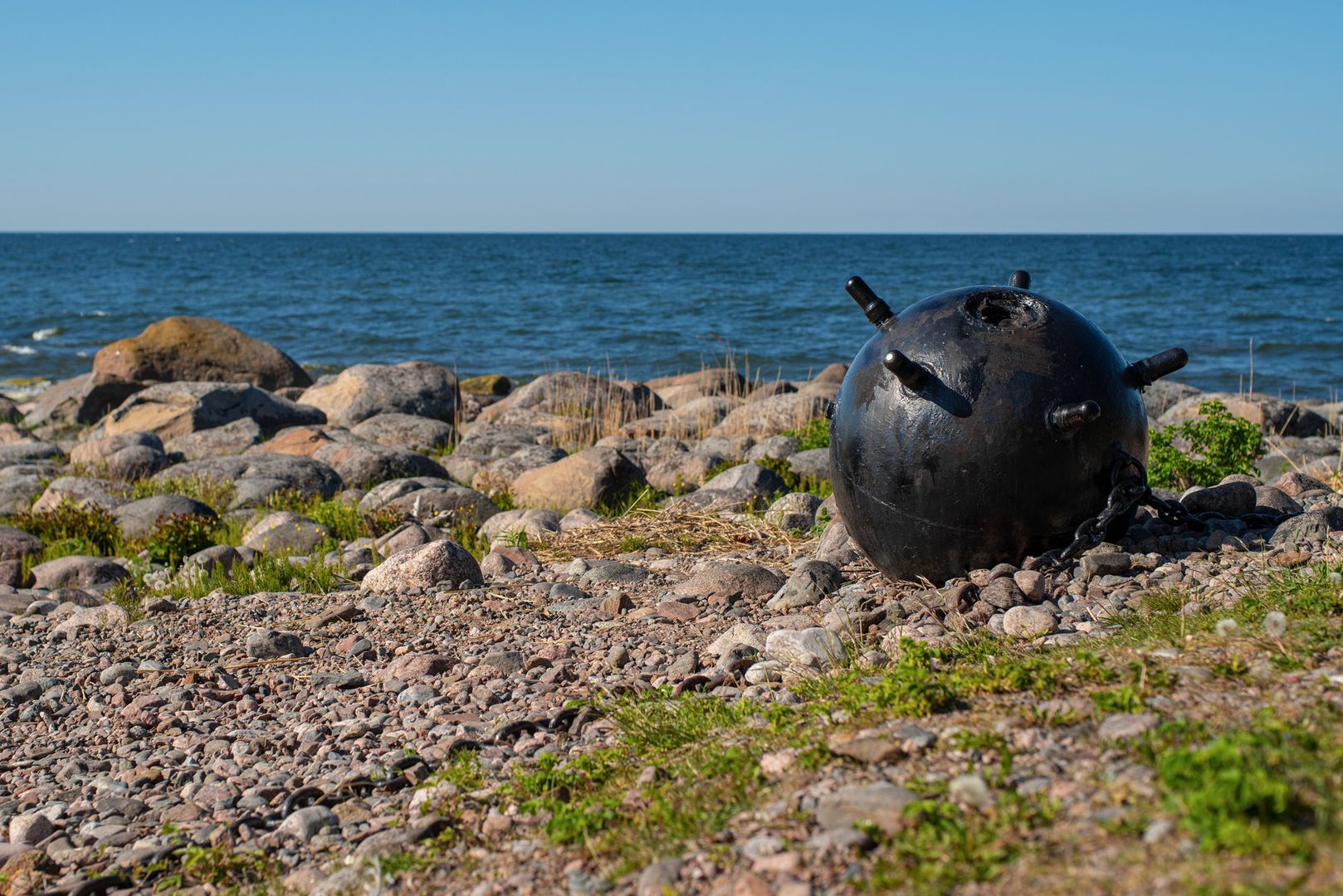 Part of World War II memorial monument placed at Juminda peninsula, Estonia. Metal bullets (defused naval mines) linked by chains.Rocky seaside.Aimur Kytt