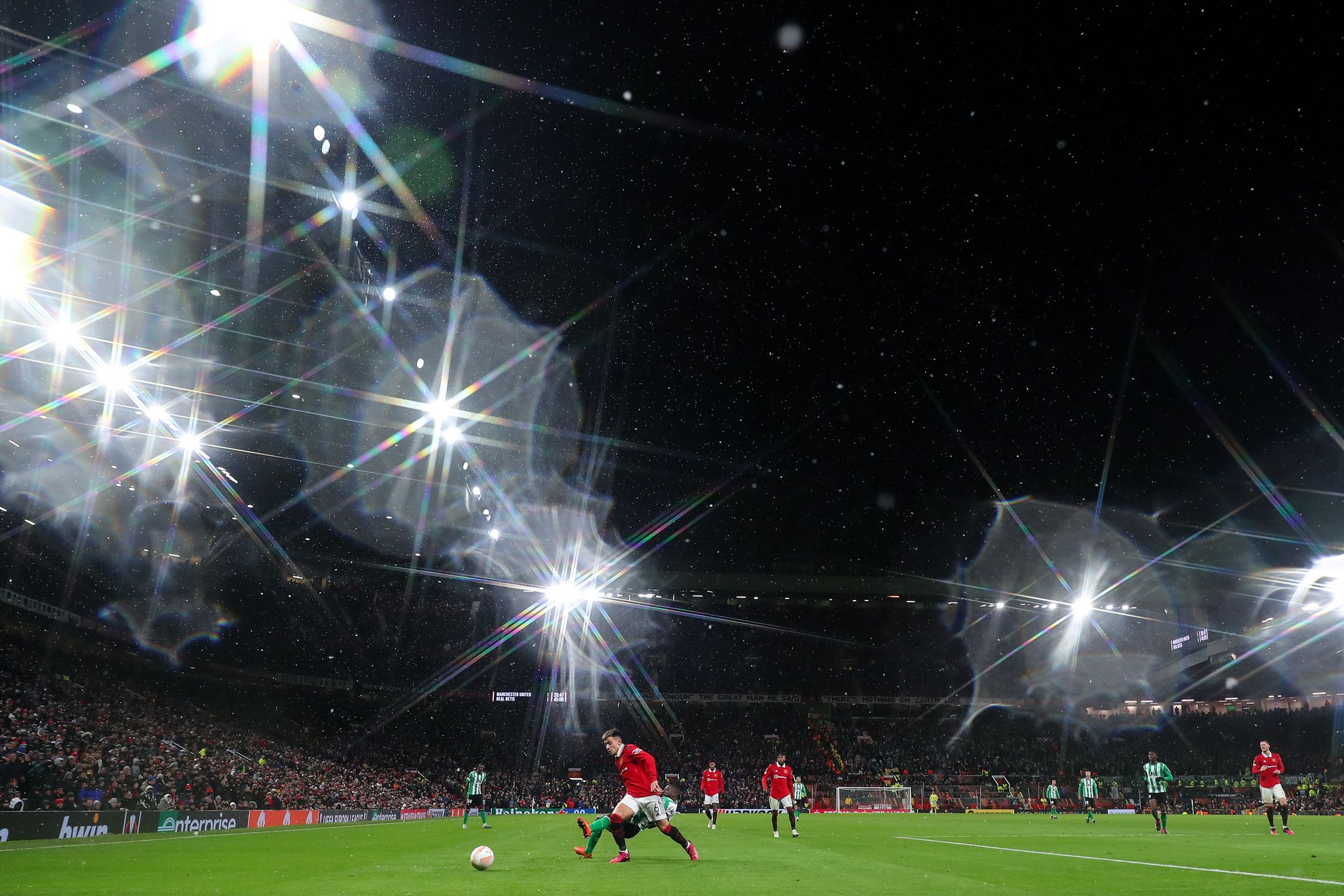 MANCHESTER, ENGLAND - MARCH 09: A general view of match action at Old Trafford, home stadium of Manchester United in snow weather conditions during the UEFA Europa League round of 16 leg one match between Manchester United and Real Betis at Old Trafford on March 9, 2023 in Manchester, United Kingdom. (Photo by Robbie Jay Barratt - AMA/Getty Images)