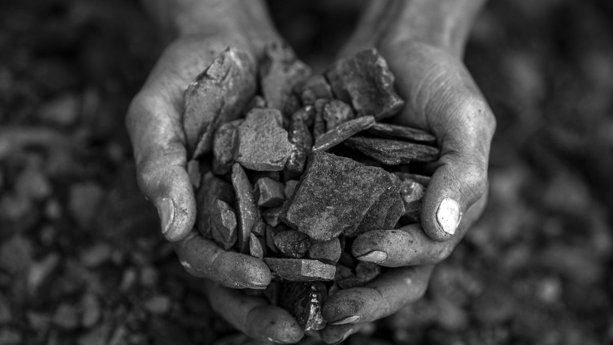 KOMATI, SOUTH AFRICA - NOVEMBER 27: (EDITOR NOTE: This image has been converted to black and white)  A man collects coal for cooking at an abandoned silo on November 27, 2024 in Komati, Mpumalanga Province, South Africa. He was working at the nearby Komati Power coal fired power station but lost his job when it was closed. The power plant, operated by the government owned company Eskom, was closed in October 2022 and it had a devastating impact on the workers who was laid off, and most of them were not offered new jobs or re-trained. The international community is putting pressure on South Africa to close their fleet of aging coal-fired plants, which provides most of the electricity in the country. The Just Energy Transition Investment Plan, primarily funded by France, Germany, the United Kingdom, the United States, and the European Union, has pledged about US$8.5 billion to South Africa for phasing out these power stations but its estimated that about US$250 billion (almost R4-trillion) is needed the next decades to finance South Africas transition from coal. Hundreds of thousands of people work in the coal industry in Mpumalanga Province alone and its uncertain how they will be re-trained or get new jobs, many who has no advanced skills. There are about 130 active coal mines (collieries) in Mpumalanga and about 600 closed ones, and the pollution is some of the worst in the world according to a recent report by Greenpeace. (Photo by Per-Anders Pettersson/Getty Images)