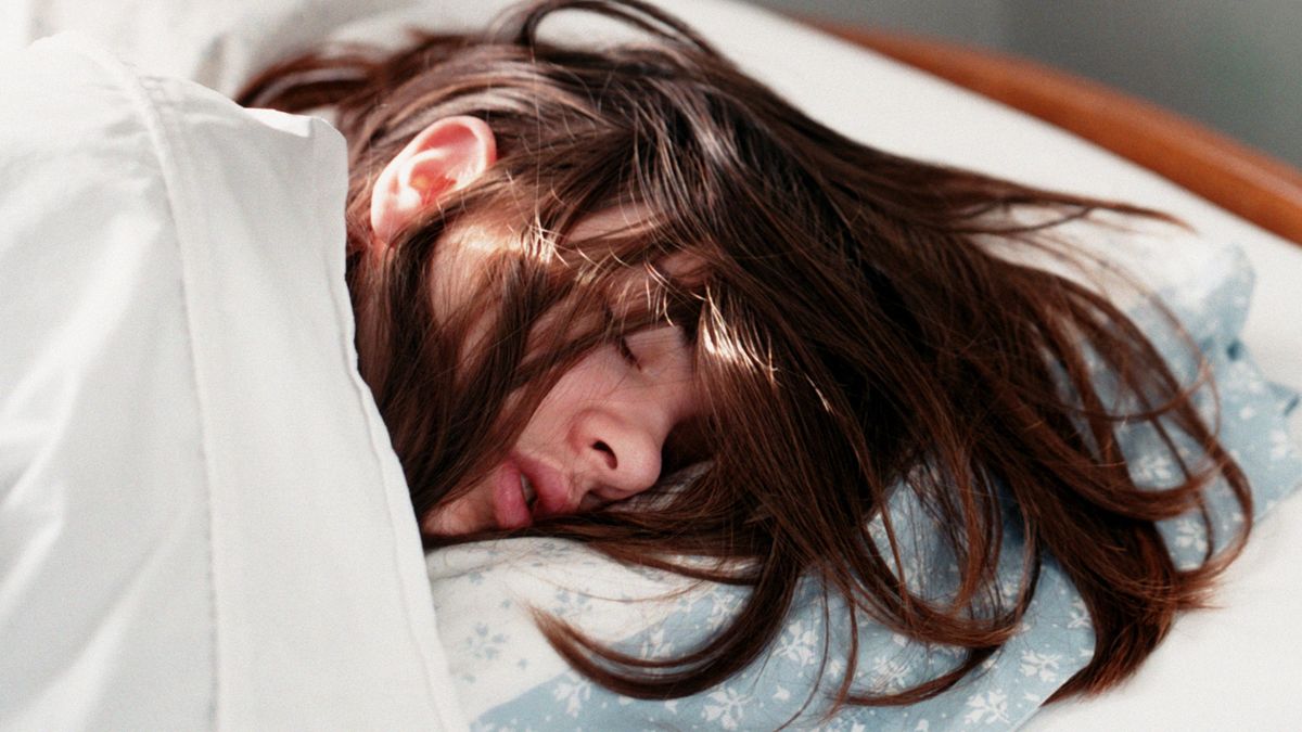 Young woman sleeping in bedShannon Fagan