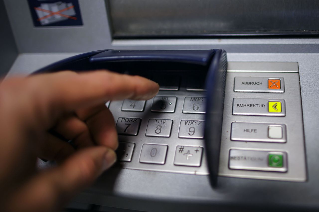 BERLIN, GERMANY - MAY 08: Symbolic photo on the subject of entering the PIN number at the ATM. A hand is typing on the keyboard of an ATM on May 08, 2024 in Berlin, Germany. (Photo by Thomas Trutschel/Photothek via Getty Images)