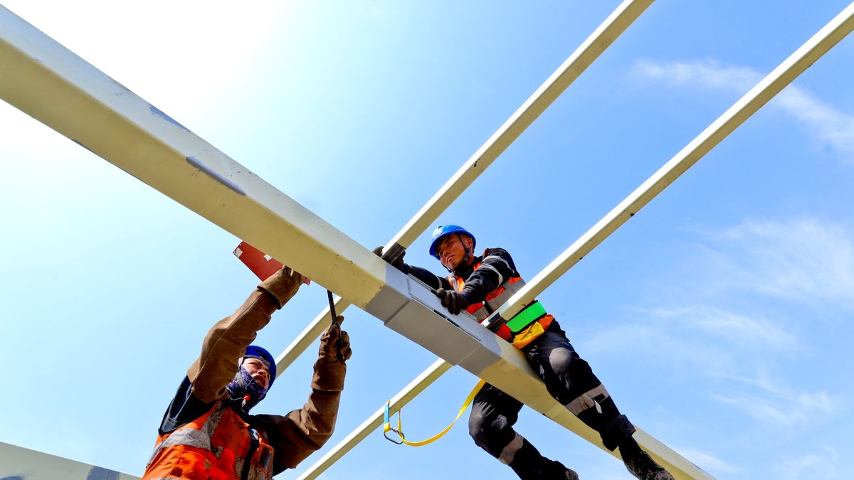 Builders are welding and installing steel structure plates for the cooling tower skin at the construction site of the 2x1000MW coal-fired unit expansion project in Zhangye, China, on May 2, 2024. (Photo by Costfoto/NurPhoto via Getty Images)
