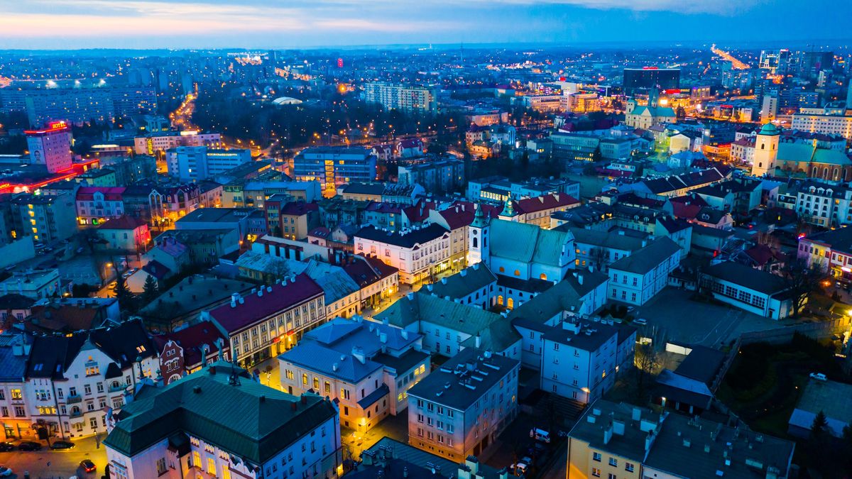 Rzeszow cityscape at twilightView from drone of lighted Rzeszow cityscape at spring twilight, Poland..rzeszow, town, polish, european, aerial, urban, view, scene, panorama, cityscape, downtown, central, district, residential, areas, buildings, townhouses, roofing, medieval, contemporary, street, square, church, holy, cross, religious, former, monastic, complex, museum, historic, monument, architectural, attraction, sights, destination, touristic, traveling, outdoor, nature, springtime, night, dusk, twilight, sky, lights, illumination, background, rzeszow, town, polish, european, aerial, urban, view, scene, panorama, cityscape, downtown, central, district, residential, areas, buildings, townhouses, roofing, medieval, contemporary, street, square, church, holy, cross, religious, former, monastic, complex, museum, historic, monument, architectural, attraction, sights, destination, touristic, traveling, outdoor, nature, springtime, night, dusk, twilight, sky, lights, illumination, background