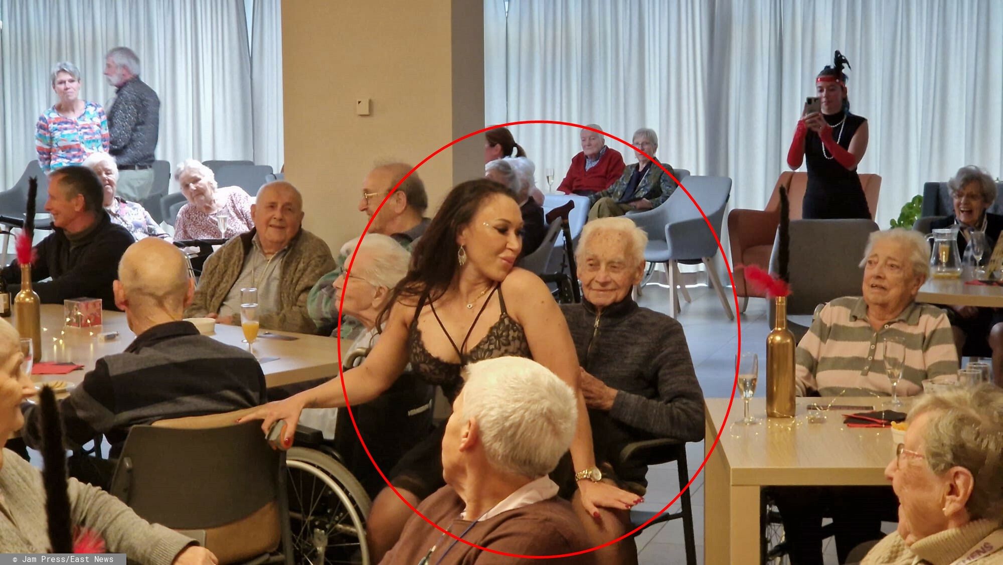 Striptiz w domu spokojnej staro?ci
WARNING, CONTAINS NUDITY

Story from Jam Press (OAPs Strip Show)

Pictured: An x-rated strip show in a retirement home.

VIDEO: OAPs treated to x-rated strip show as part of their Christmas wish

A raunchy video has captured the bizarre moment OAPs in a retirement home were given their Christmas wish ? an X-rated strip show.

It?s clear the elderly certainly know how to party.

The gift was given as part of Elderly Week, a special week the home organizes each year in the run-up to Christmas.

Those who live there are asked to hang their greatest wish on the twinkling tree, which staff members try to grant.

This year, it appears some people were on the naughty list, reports What's The Jam.

In the clip, two strippers walk in ? male and female ? ready to give the OAPs a show they?re bound to never forget.

As the music played, the residents enjoyed a drink at their tables while a woman paraded the room in a racy black lace outfit.

She later used an American flag to hide her modesty, before dropping it to the floor and dancing in nothing but her stockings and stilettos.

The residents looked on ? some shocked and others laughing with huge smiles on their faces.

One elderly woman really got into it; helping the stripper pull down her underwear.

The male stripper prompted a similar reaction from the OAPs, as he wore a hat, boots, and a tiny pair of pants.

He covered his lower body with a black towel, before later going up to a female resident and revealing himself to have nothing underneath.

She had no idea where to look and the other ladies sitting around the table broke out into laughter.

They all clapped as he finished his routine, confirming their enjoyment.

The event, which took place in St-Mathildia, Belgium, has also enjoyed a little less risqu� pampering session, coffee, and a party.

They?ve even had St-Mathildis Got Talent, where performances were put on by the staff.

Caf� Moulin Rouge, the strip show, took place on 20 November in the r