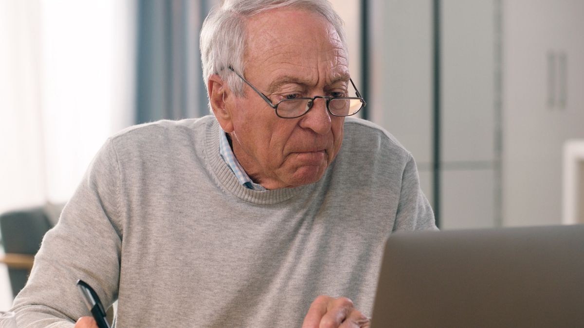 Laptop, paper and senior man reading, analysis and writing home summary of retirement pension, insurance or finance. Paperwork, computer or old person check financial info, web report or bank accountLaptop, paper and senior man reading, analysis and writing home summary of retirement pension, insurance or finance. Paperwork, computer or old person check financial info, web report or bank accountSean Anthony Eddy