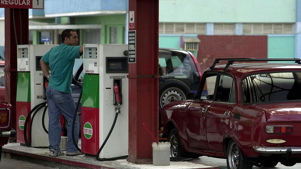 Cuba Suspends Purchases With U.S. Currency
HAVANA, CUBA - MAY 11:  A gas station attendant waits for more customers May 11, 2004 in Havana, Cuba. President Fidel Castro's government announced the suspension of most goods bought with US dollars. Castro blamed the new measure on the Bush Administration's decision last week to tighten trips and cash remittances to the island.  (Photo by Jorge Rey/Getty Images)
Jorge Rey
street build bus people book economy food