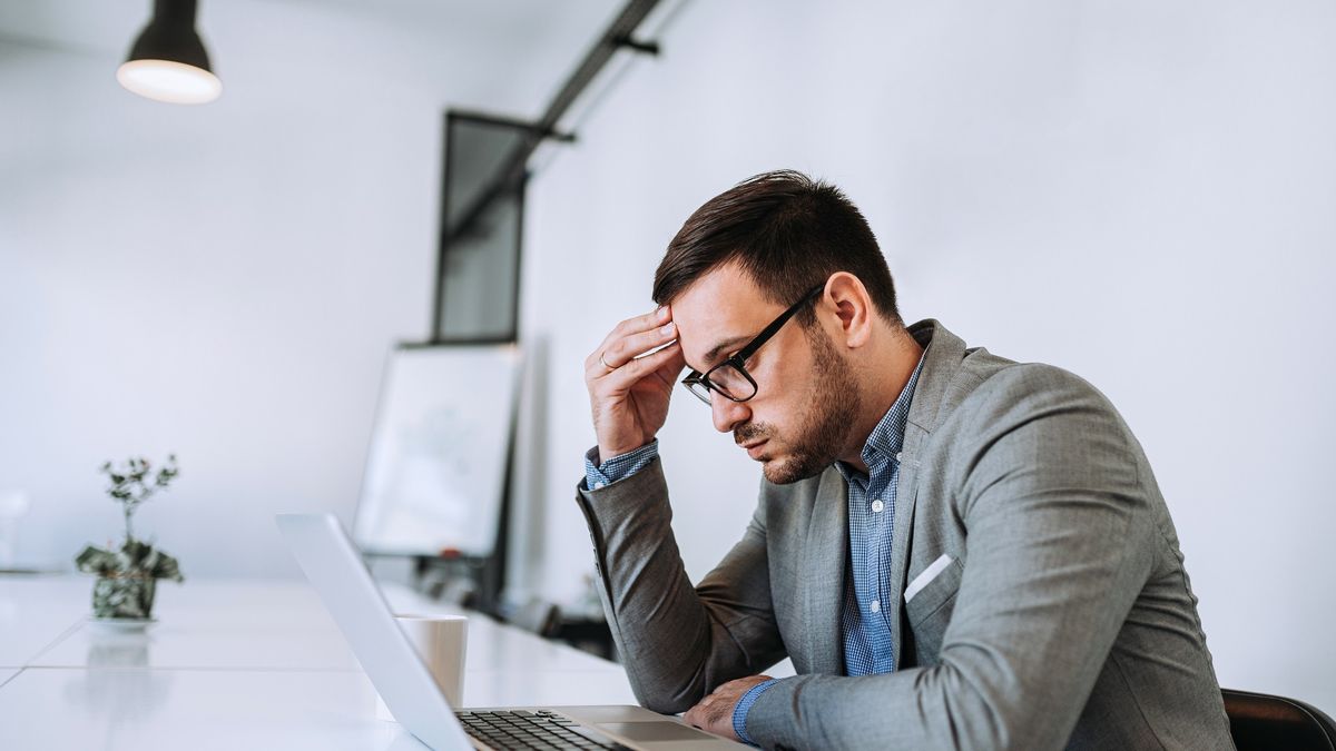 Businessman stressed out at work in casual officeunhappy, upset, lifestyle, concentration, men, workplace, caucasian, professional, frustration, person, adult, job, indoors, pain, emotional, one, exhaustion, technology, depression, overworked, occupation, office, laptop, casual, businessman, work, young, computer, man, worried, stress, business, tired, people, headache, sitting