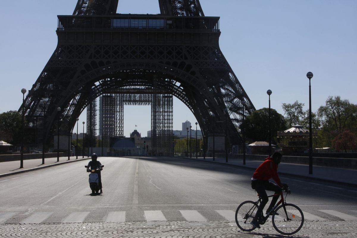 A man rides his bicycle near Eiffel Tower in Paris, on April 14, 2020, during the lockdown in France to attempt to halt the spread of the novel coronavirus COVID-19.
 (Photo by Mehdi Taamallah/NurPhoto via Getty Images)