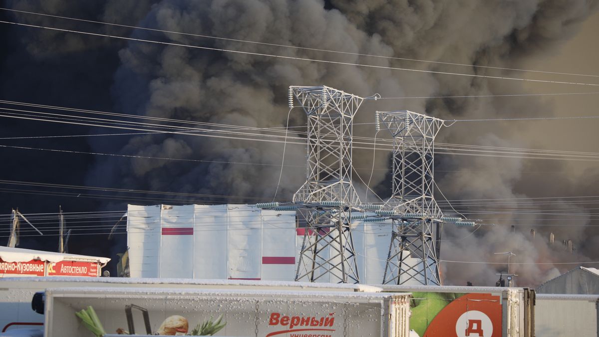 SAINT PETERSBURG, RUSSIA - JANUARY 13: Smoke rises after fire broke out at a warehouse of the Russian Internet store Wildberries in Shushary of St. Petersburg, Russia on January 13, 2024. According to the Ministry of Emergency Situations, the fire area was 5.000 square meters. 270 people and 57 pieces of equipment are involved in extinguishing the fire. As reported by Wildberries, people who were in the warehouse were evacuated. Sellers and buyers will receive compensation for damaged or lost items, the company announced. (Photo by Sergey Kovalev/Anadolu via Getty Images)