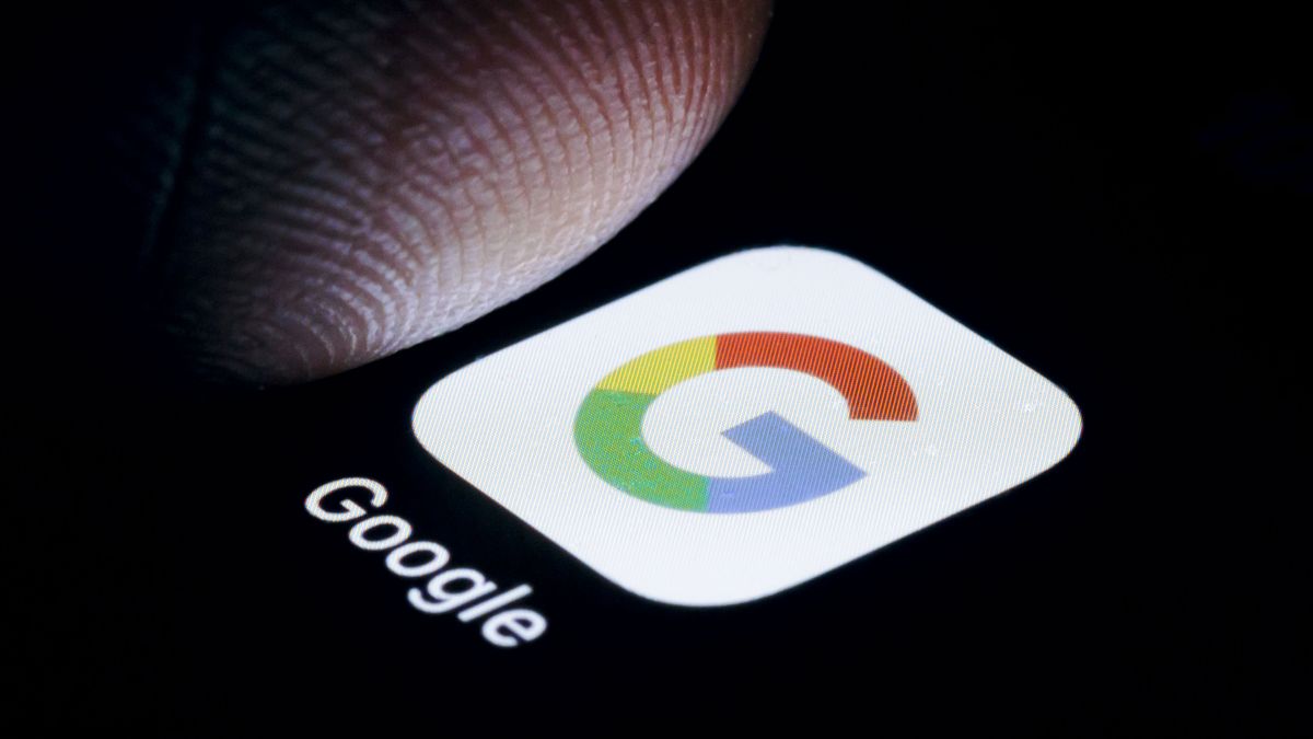 BERLIN, GERMANY - OCTOBER 06: In this photo illustration the Logo of Google App is illuminated on a smartphone close to a finger on October 06, 2023 in Berlin, Germany. (Photo Illustration by Thomas Trutschel/Photothek via Getty Images)