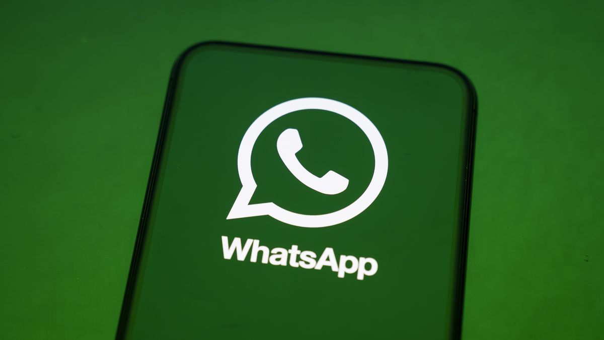 In Créteil, France, on September 29, 2025, the WhatsApp logo appears on a smartphone reflecting a green illustration. Meta, the parent company of WhatsApp and Meta AI, makes the Artificial Intelligence assistant mandatory in its instant messaging app. (Photo Illustration by Samuel Boivin/NurPhoto via Getty Images)