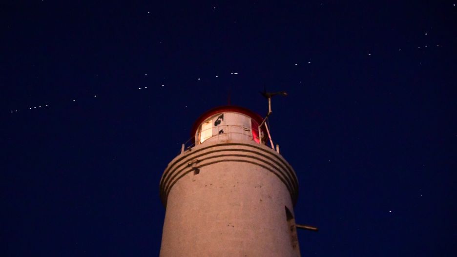 VLADIVOSTOK, RUSSIA - APRIL 27, 2020: 60 of the Starlink Internet communication satellites of Elon Musk's SpaceX private spaceflight company seen in the night sky. On April 22, 2020, SpaceX successfully launched 60 Starlink satellites into orbit on the Falcon 9 rocket from NASA's Kennedy Space Center at Cape Canaveral. The Starlink project is aimed at providing low-cost internet to remote locations; SpaceX is planning to launch into orbit about 30,000 satellites. Following the launch of the first batch of the Starlink satellites, the International Astronomical Union (IAU) and the US National Radio Astronomy Observatory (NRAO) expressed concerns about the satellites being too bright and forming a 'megaconstellation' and thus causing serious problems for astronomers.  Yuri Smityuk/TASS (Photo by Yuri Smityuk\TASS via Getty Images)