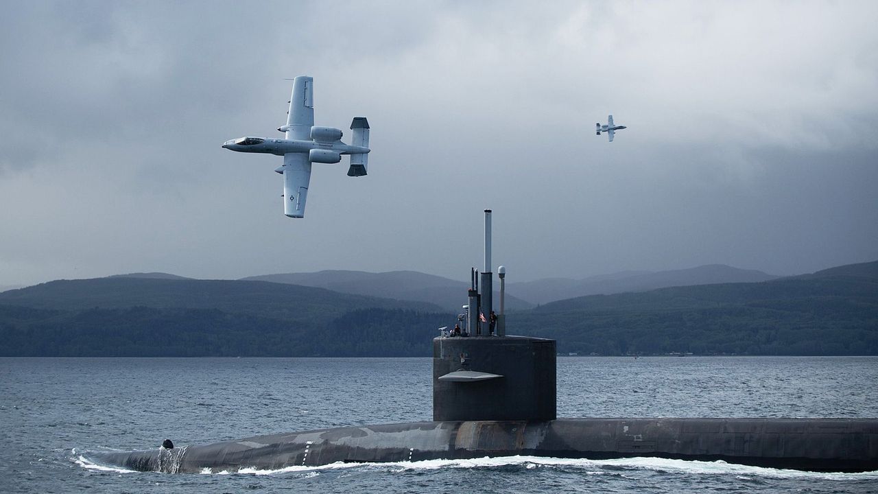 USS Nebraska escorted by A-10 Thunderbolt II