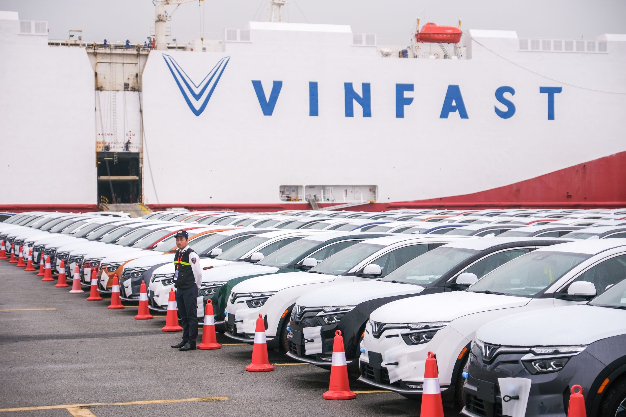 VinFast LLC's EV VF8 vehicles bound for shipment at the port in Haiphong, Vietnam, on Friday, Nov. 25, 2022. VinFast, which said in July that it had signed agreements with banks to raise at least $4 billion to help its US expansion, has about 73,000 global reservations for its EVs, according to the company. It has secured about $1.2 billion in incentives for its planned EV factory in North Carolina, where it intends to start production in 2024, according to the auto manufacturer.  Photographer: Linh Pham/Bloomberg via Getty Images