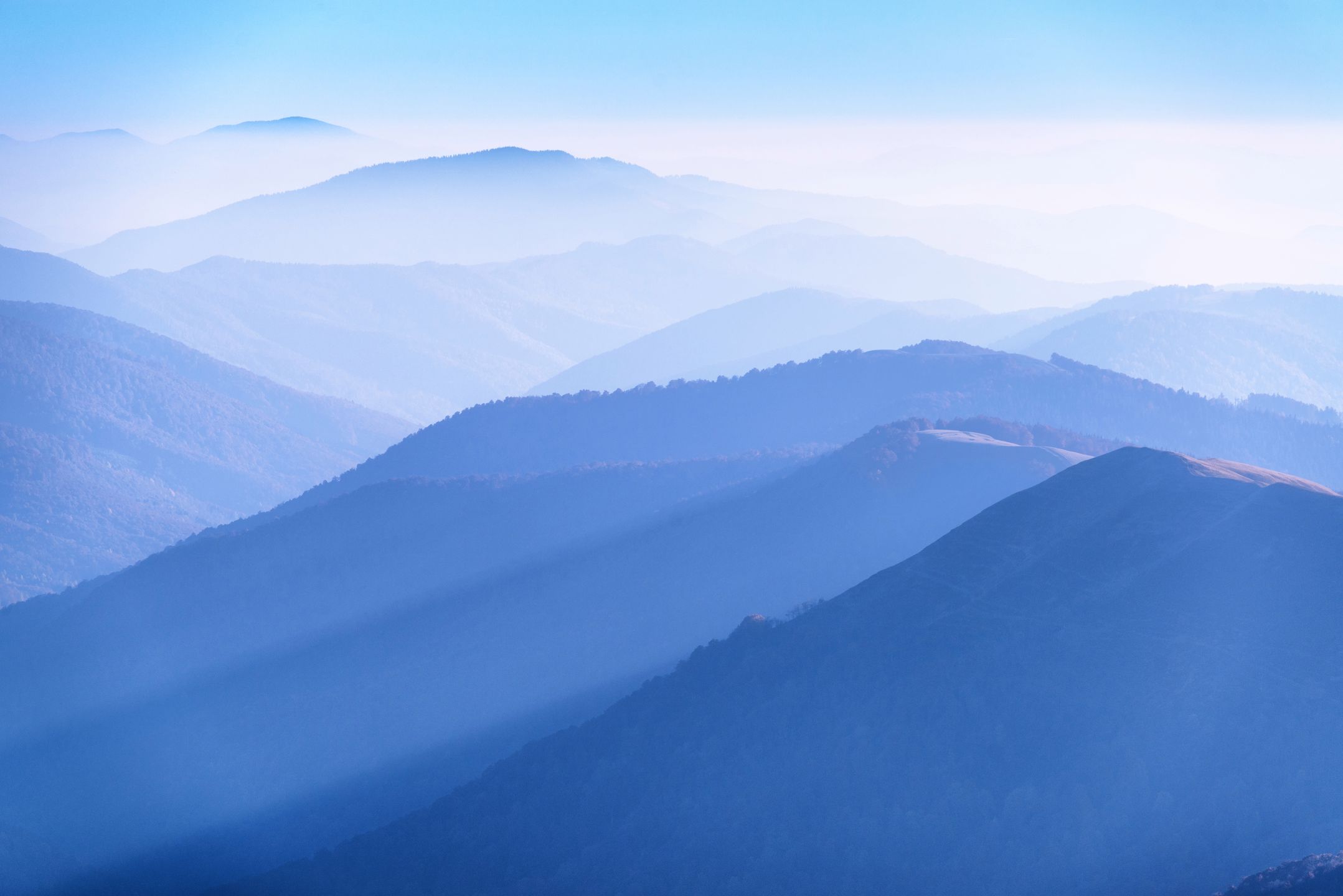 Blue mountain ranges silhouettes with tonal perspective 