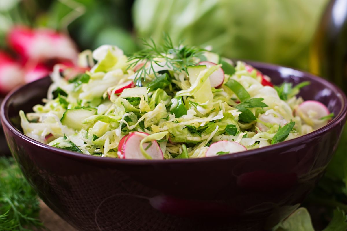 Coleslaw made from spring greens, cucumber, and radish is an excellent side dish for dinner.