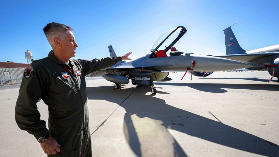 Moreno Valley, CA - February 08: U.S. Air Force Lt. Col Mark Janksy, who pilots the F-16 fighter jet, points to the aircraft after a Super Bowl air defense press briefing at March Air Reserve Base near Moreno Valley on Tuesday, Feb. 8, 2022. Janksy will join other officials to protect the skies around SoFi Stadium in Inglewood during the Super Bowl this Sunday. (Photo by Watchara Phomicinda/MediaNews Group/The Press-Enterprise via Getty Images)