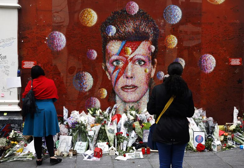 Fani składają kwiaty pod twarzą Davida Bowie w Londynie