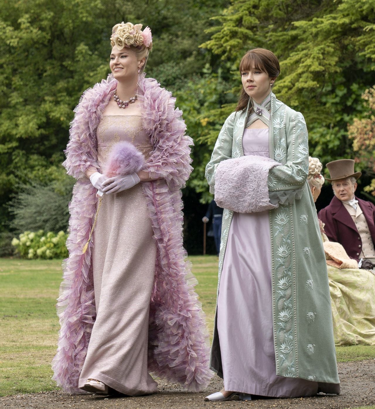 Jessica Madsen as Cressida Cowper, Claudia Jessie as Eloise Bridgerton with a muff