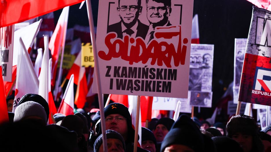 'Solidarity with Kaminski and Wasik' banner is seen during right-wing 'Free Poles Protest' in Warsaw, Poland on January 11, 2024. Members of the previous government called people to demonstrate against new pro-EU government which dismissed executives from state media which served the right-wing Law and Justice Party during its eight years in power. Protestors also demonstrated against the arrest of Mariusz Kaminski and Maciej Wasik, lawmakers for Law and Justice (PiS) party, sentenced to two years in prison for abuse of power in 2007, when they were in charge of the anti-corruption agency CBA. (Photo by Beata Zawrzel/NurPhoto via Getty Images)