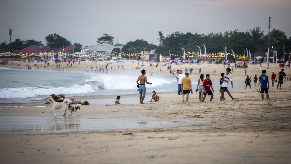 BALI, INDONESIA - NOVEMBER 13: People walk along the ocean as there are places for hiking, yoga and spa centers in Bali, Indonesia on November 13, 2022. Many tourists visit Bali, which is one of the millions island in Indonesia, every season of the whole year. (Photo by Emin Sansar/Anadolu Agency via Getty Images)