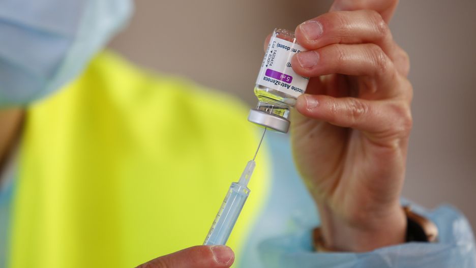 A nurse prepares an AstraZeneca vaccine from a vial after this vaccine was approved again in Spain. The massive vaccination against COVID-19 continues in Granada, Spain, on March 25, 2021. (Photo by Álex Cámara/NurPhoto via Getty Images)