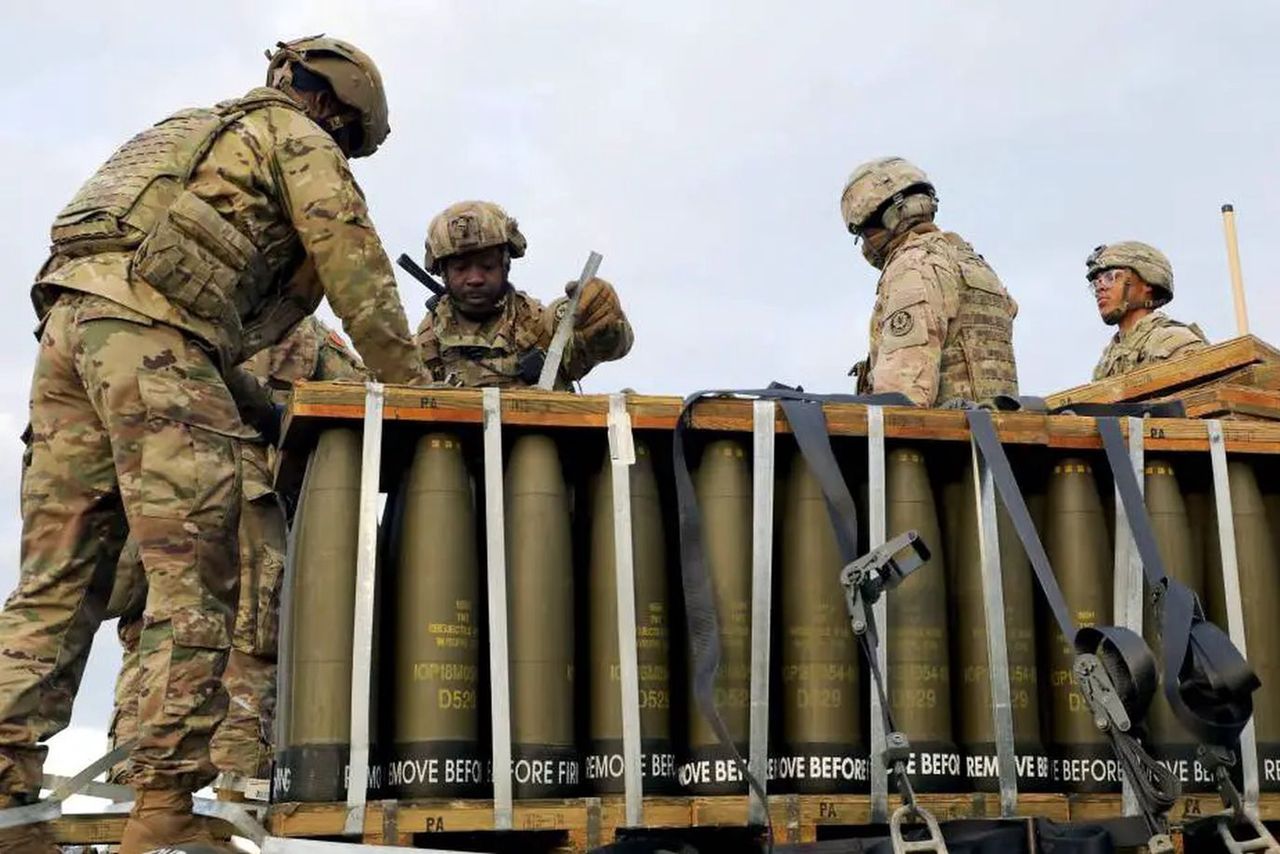 Soldiers of the United States Army transporting 155 mm caliber shells