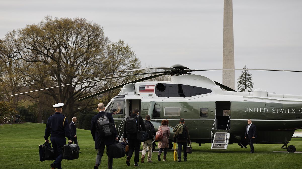 WASHINGTON, DC - MARCH 31: Military and civilian aides prepare to board Marine One with President Joe Biden as they depart the White House on March 31, 2023 in Washington, DC. Biden and first lady Jill Biden are traveling to Rolling Fork, Mississippi, to tour the community that was devastated by a tornado last week. (Photo by Chip Somodevilla/Getty Images)