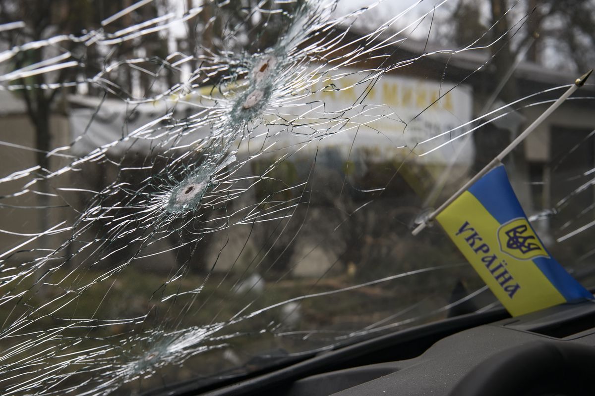 Ukrainian flag and Bullet holes on a screen of shelled civil car in the recaptured by the Ukrainian army Bucha city near Kyiv, Ukraine, 04 April 2022. (Photo by Maxym Marusenko/NurPhoto via Getty Images)