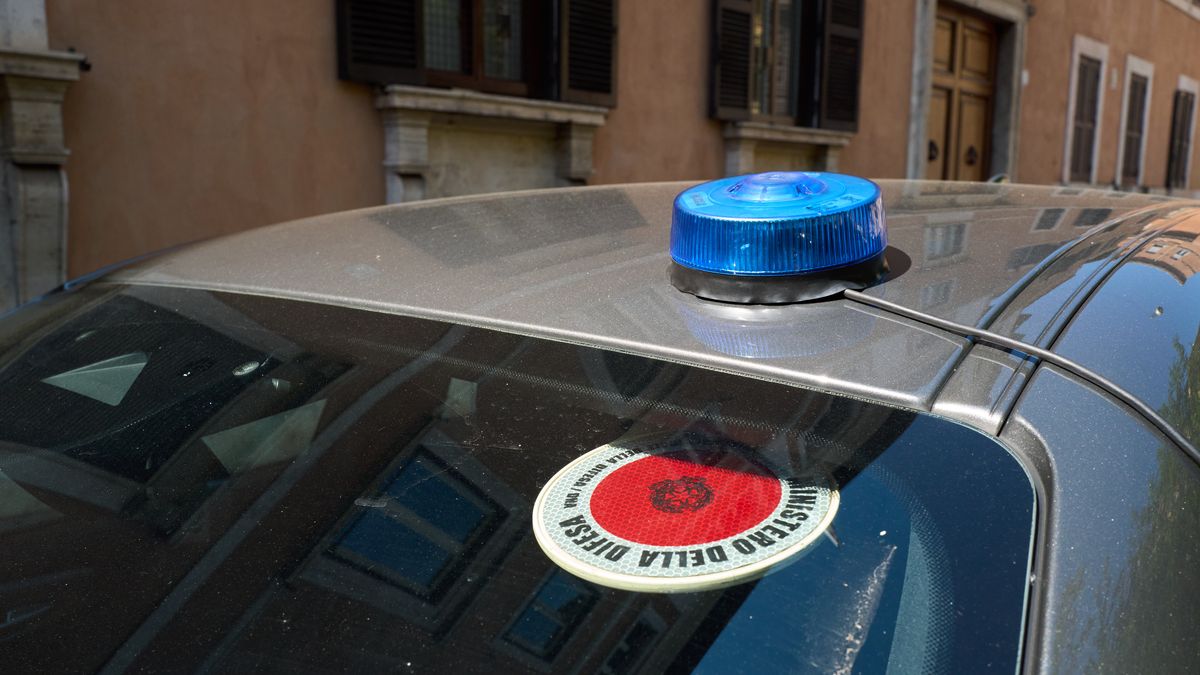 A Carabinieri official vehicle is parked on a street in central Rome, Italy, on April 8, 2026. A blue emergency light, standard equipment on Italian law enforcement and security vehicles, is mounted on the roof, while the rear windshield displays the circular reflective identification badge of the Ministero della Difesa bearing the emblem of the Italian Republic. The Carabinieri, Italy's national military police force operating under the Ministry of Defence, maintain a significant institutional presence in Rome, seat of the national government. The vehicle is set against the ochre facade of a typical Roman building with wooden shutters. (Photo by Matteo Della Torre/NurPhoto via Getty Images)