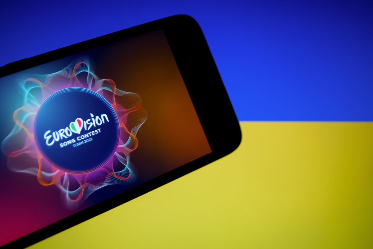 In this photo illustration an Eurovision 2022 logo seen displayed on a smartphone screen with flag of Ukraine in the background in Athens, Greece on May 11, 2022. (Photo illustration by Nikolas Kokovlis/NurPhoto via Getty Images)