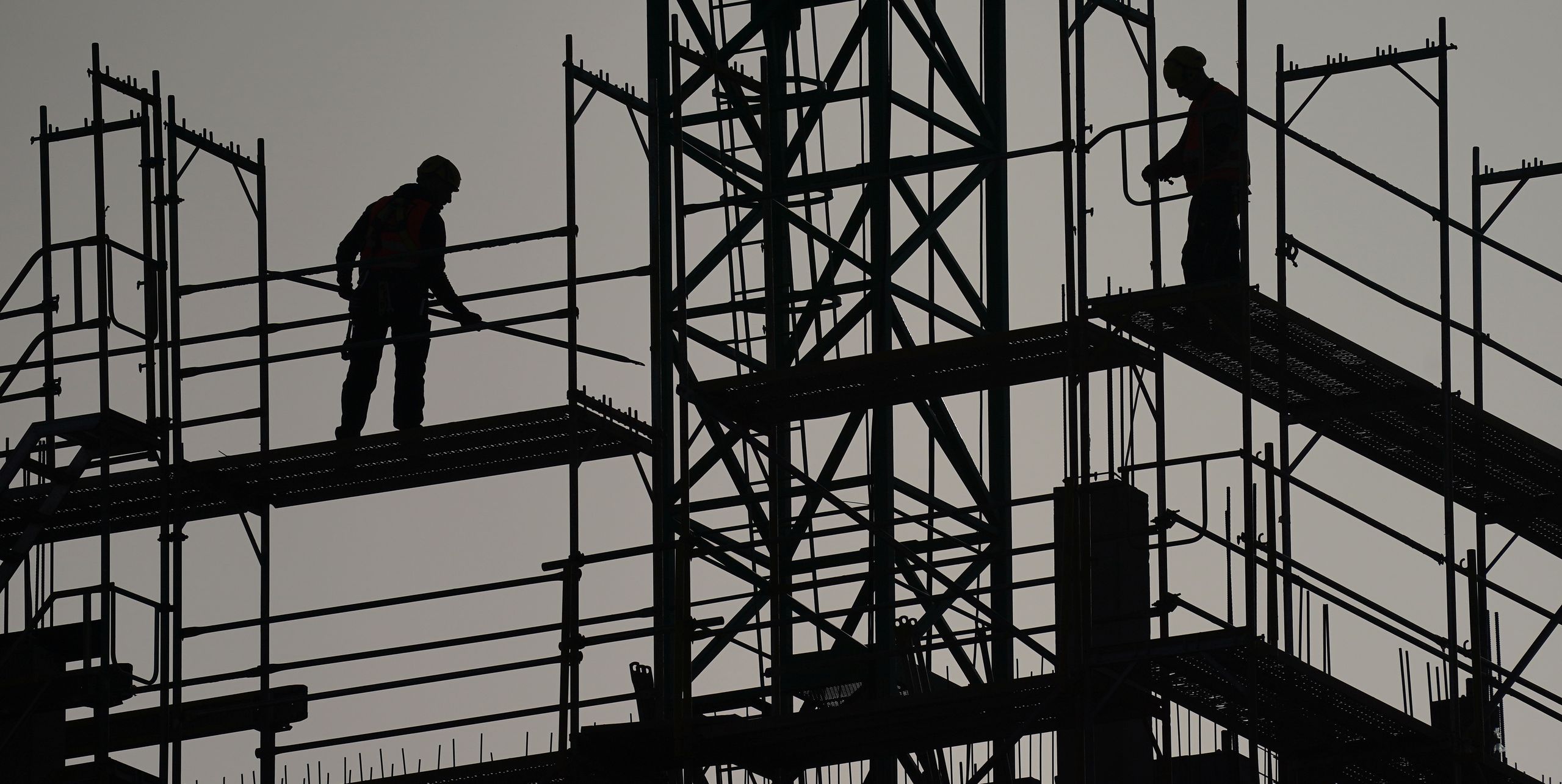BERLIN, GERMANY - FEBRUARY 23: Workers stand on scaffolding on a residential building under construction in the city center on February 23, 2021 in Berlin, Germany. German government ministers as well as Chancellor Angela Merkel spoke today on Germany's housing situation. Housing prices have risen substantially in most larger cities across Germany in recent years and the federal government has sought to counter the rise with a "housing offensive" of expanded construction. (Photo by Sean Gallup/Getty Images)