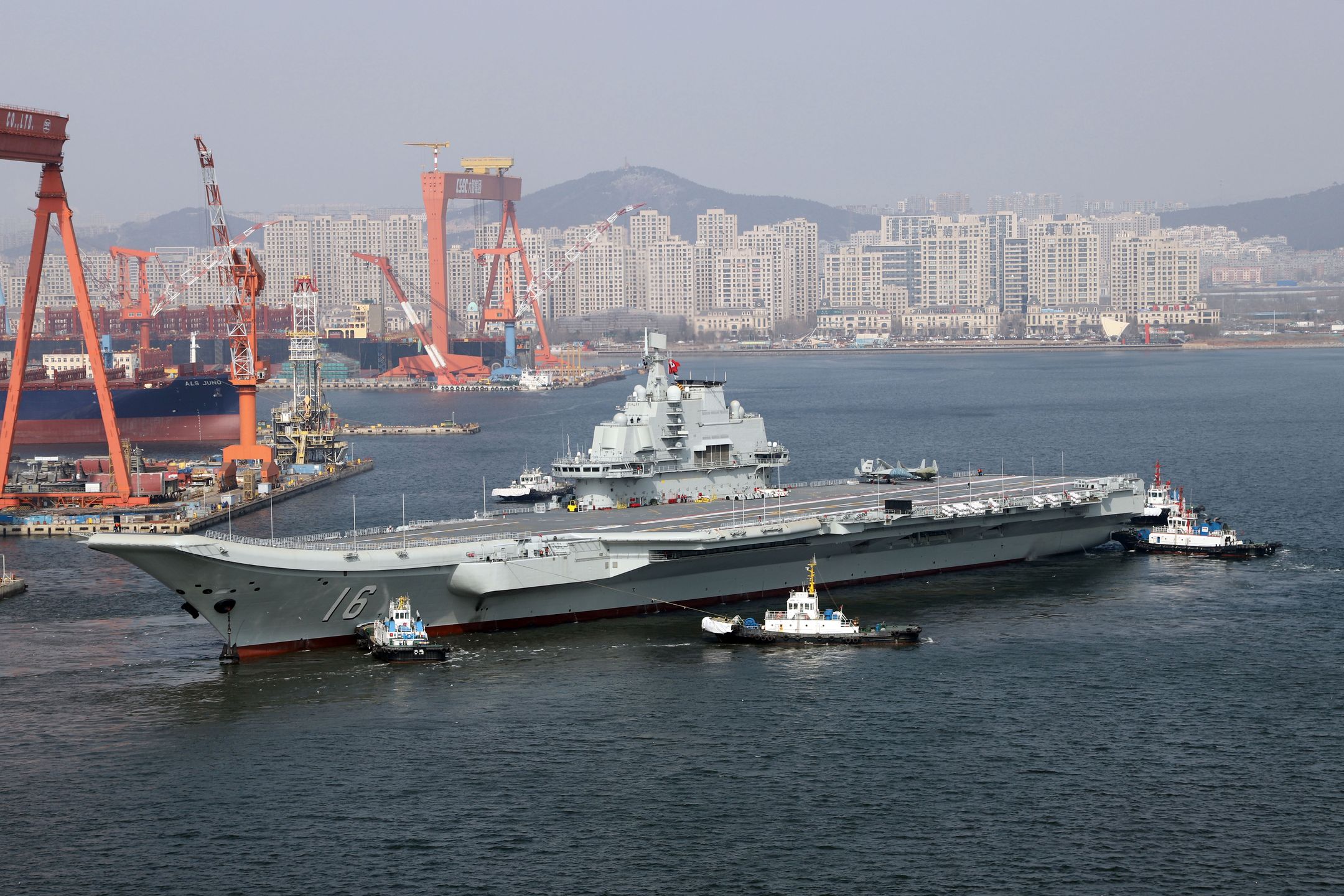 DALIAN, CHINA - FEBRUARY 29: Aircraft carrier Liaoning sets for sea trial at Dalian shipyard with the help of towboats after nearly one year of maintenance on February 29, 2024 in Dalian, Liaoning Province of China. (Photo by VCG/VCG via Getty Images)