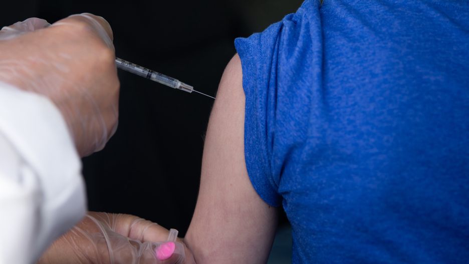A child receives a dose of a COVID-19 vaccine during a drive-thru vaccination clinic for children in Farmington Hills, Michigan, U.S. on Thursday, May 13, 2021. The Covid-19 vaccine made by Pfizer Inc. and BioNTech SE was cleared for use in children ages 12 to 15 years old this week, fueling the inoculation campaign. Photographer: Emily Elconin/Bloomberg via Getty Images
