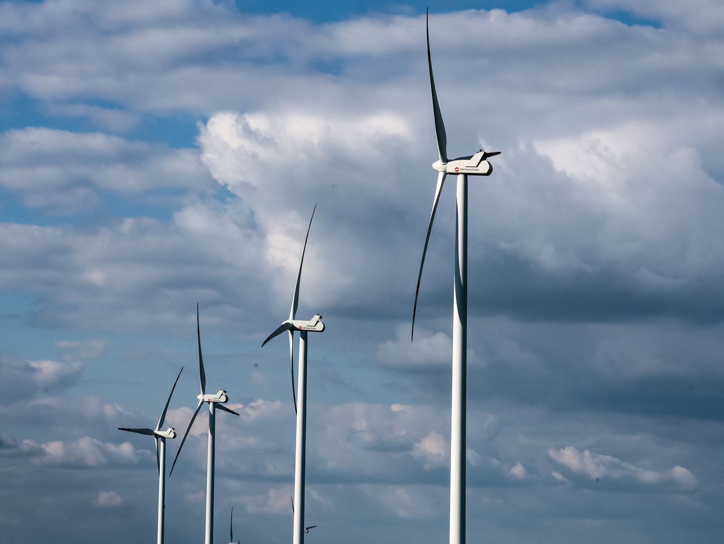 Wind turbines are seen on a wind farm on a field between agricultural produce in a countryside in a village near Radom, Poland on May 19, 2025. (Photo by Dominika Zarzycka/NurPhoto via Getty Images)