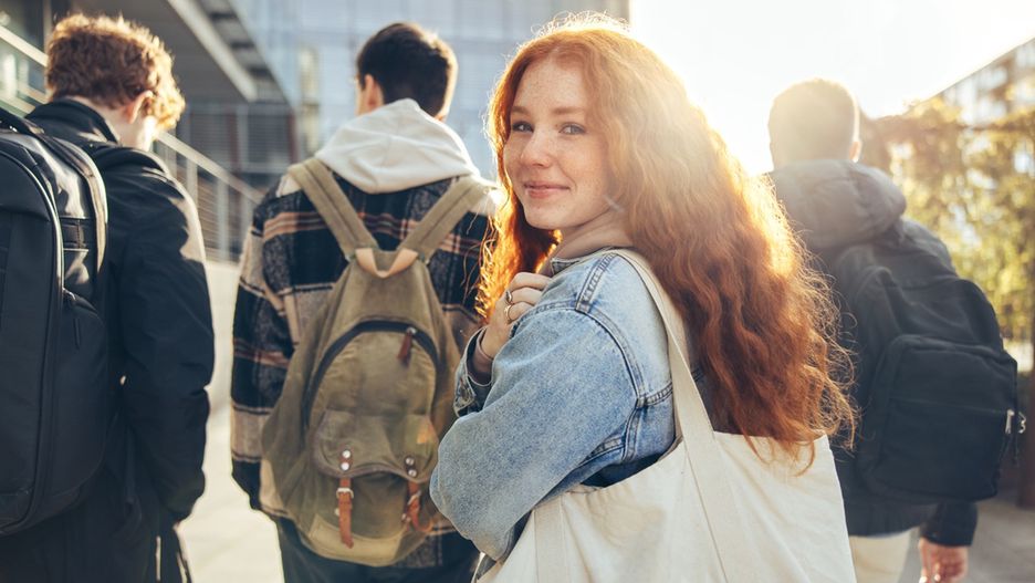 Female student glancing back while going for a class in college. Girl walking with friends going for class in high school.
bag,campus,class,classmates,college,friends,girl,glancing,group,happy,high,high school,looking,outdoors,people,rear,school,students,teenager,university,view,walking,woman,young,youth