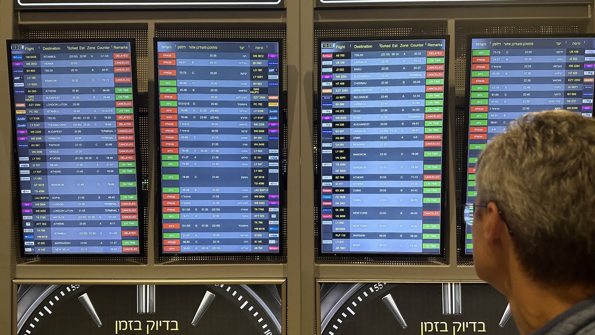 TEL AVIV, ISRAEL - OCTOBER 8: A man looks at the board showing departure schedules at Ben Gurion Airport, Israel's only international airport, after many flights from abroad are cancelled due to the attacks launched by Palestinian factions in Tel Aviv, Israel on October 8, 2023. (Photo by Turgut Alp Boyraz/Anadolu Agency via Getty Images)