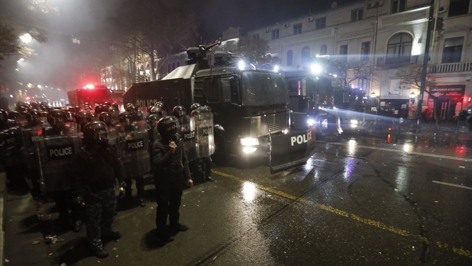 TBILISI, GEORGIA - DECEMBER 06: Police officers intervene the demonstrators as they gather in front of the parliament building to protest against the decision to suspend Georgia's EU accession negotiations until 2028, in its eighth day, in Tbilisi, Georgia on December 06, 2024. (Photo by Mirian Meladze/Anadolu via Getty Images)