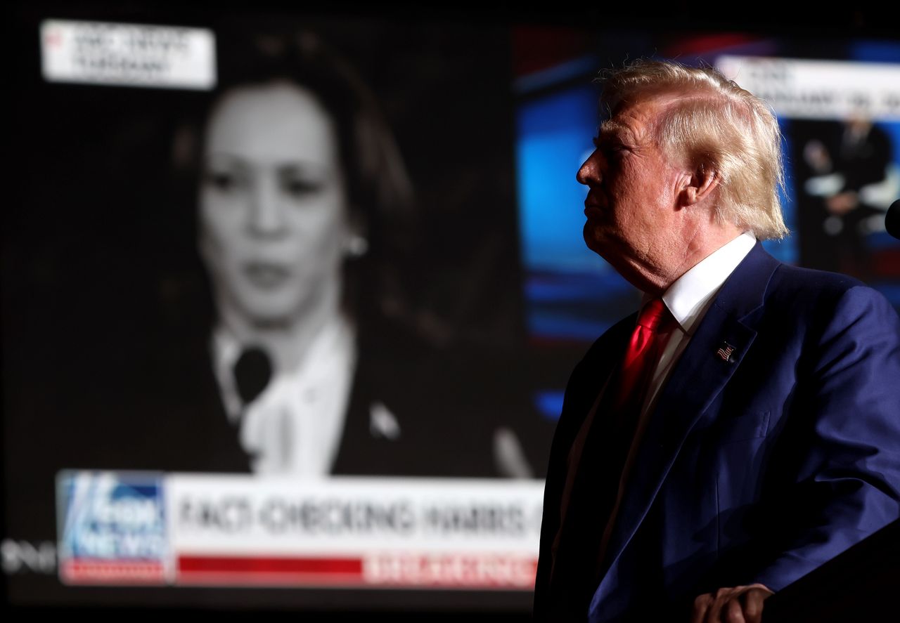 Former President Donald Trump and Kamala Harris interview in the background