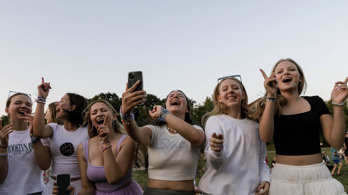 WARSAW, POLAND - 2024/08/01: Taylor Swift's fans are singing and dancing holding their mobile phones outside the National Stadium during the Eras Tour. American singer Taylor Swift will play three concerts in Warsaw, Poland on August 1, 2, and 3 as part of her Eras Tour at the National Stadium (PGE Stadion Narodowy). Thousands of people from Poland and other countries will attend the concert. However, some fans, known as Swifties, who did not secure tickets gathered around the stadium to hear the star. (Photo by Volha Shukaila/SOPA Images/LightRocket via Getty Images)