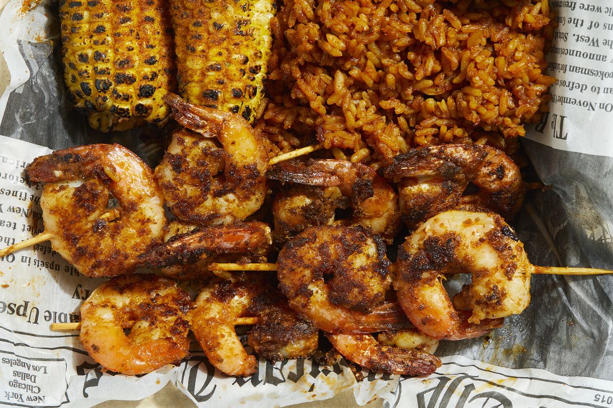 BRENTWOOD, MD - MARCH 27: Shrimp Suya with Grilled Corn and Jollof Rice at Spice Kitchen photographed in Brentwood, Maryland on March 27, 2022. (Photo by Deb Lindsey for The Washington Post via Getty Images).