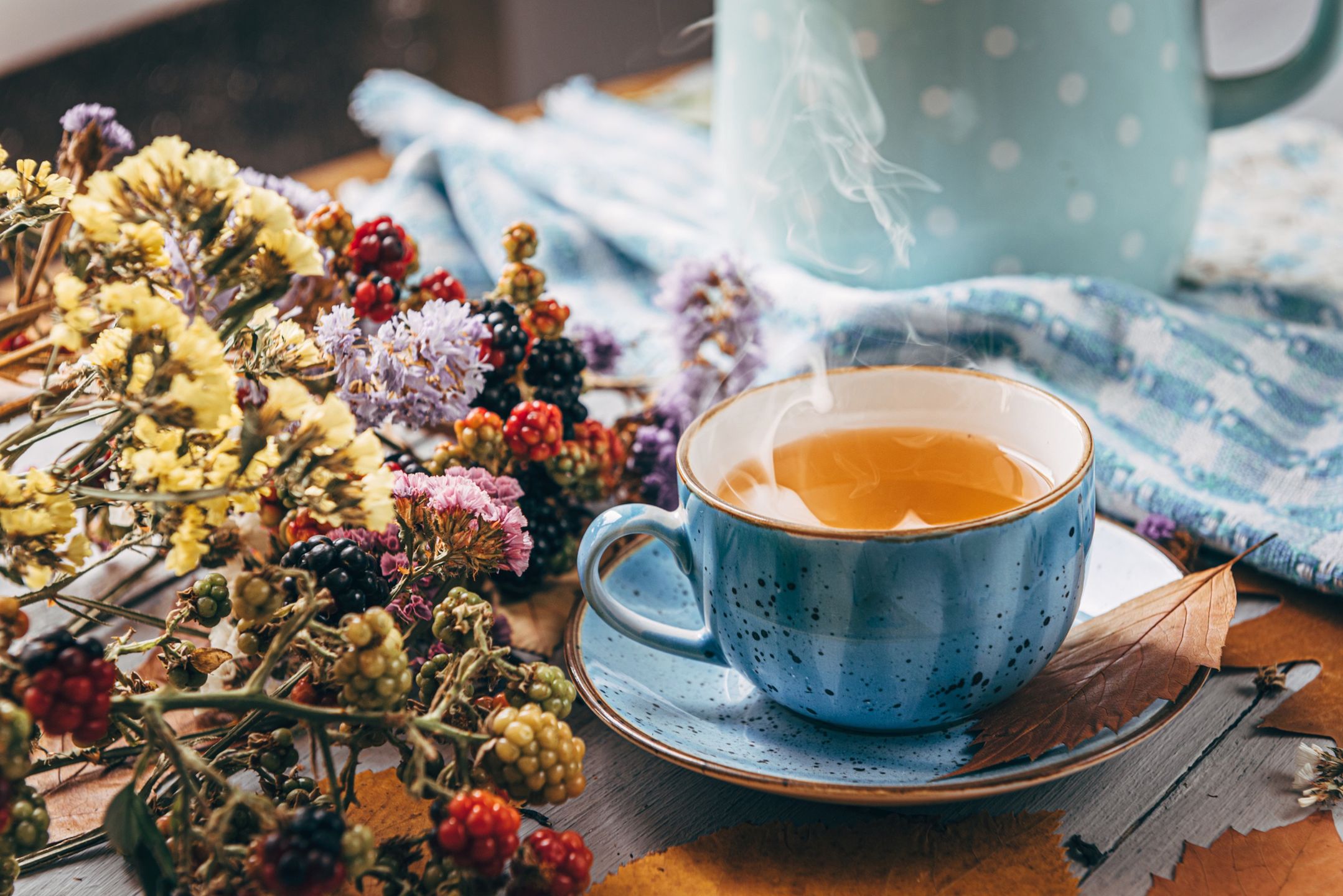 herbata autumn warming tea on a wooden table with autumn tree leaves lying nearbyautumn,morning,cup,drink,tea,mug,comfort,relaxation,citrus,medicine,prevention,temperature,herbal,vitamin,automn,hygge,homemade,tasty,day,warm,hot,wooden,fall,scarf,cozy,winter,background,table,home,season,coffee,lifestyle,beverage,red,cold,leaves,healthy,lemon,rustic,life,still,yellow,concept,mood,health,relax