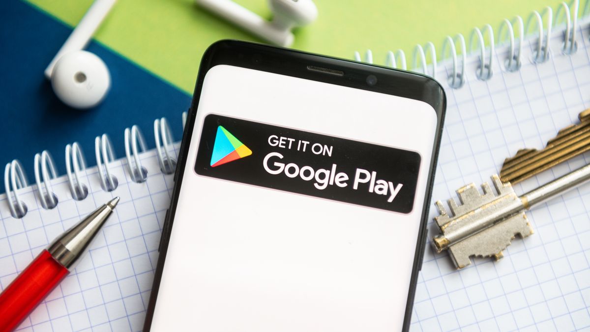 POLAND - 2021/02/09: In this photo illustration, a Google Play logo seen displayed on a smartphone with a pen, key, book and headsets in the background. (Photo Illustration by Mateusz Slodkowski/SOPA Images/LightRocket via Getty Images)