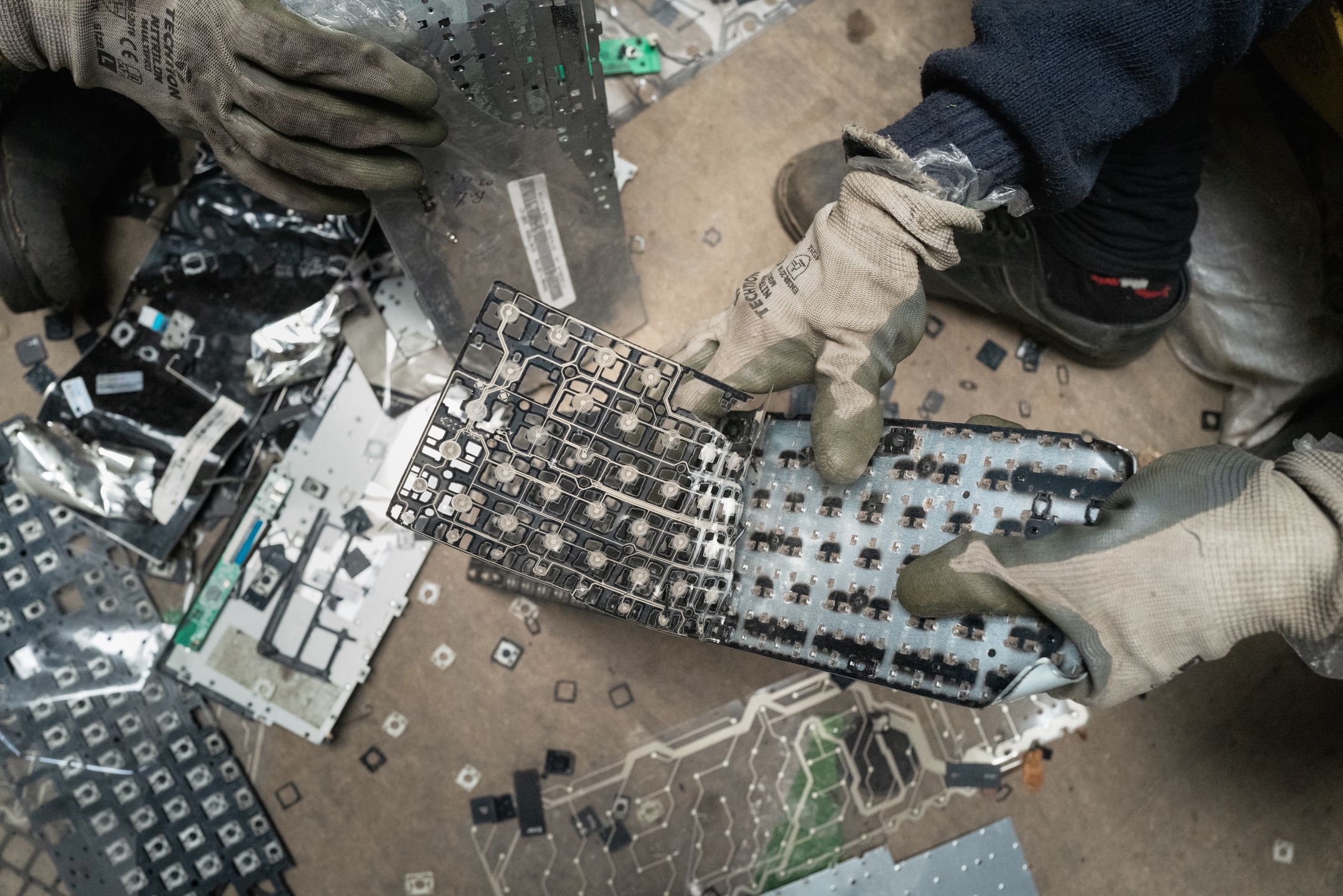 BENGALURU, INDIA - AUGUST 09: Workers dismantle electronic waste at E-Parisaraa on August 09, 2024 in Bengaluru, India. India is the third largest electronic waste producer in the world and generates approximately 2 million tons of e-waste annually. Computer devices account for nearly 70% of e-waste. Although efforts are made to formalise e-waste, more than 95% is illegally recycled by informal waste pickers. (Photo by Elke Scholiers/Getty Images)