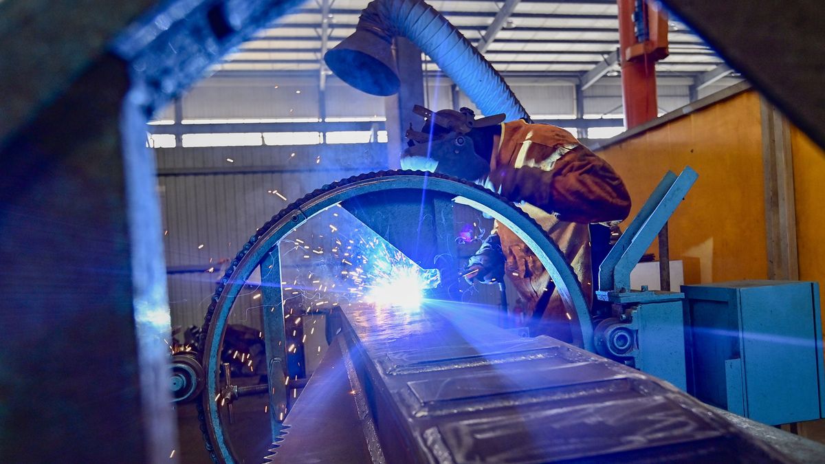 QINGZHOU, CHINA - MARCH 31: An employee works on the assembly line of intelligent machinery at a workshop on March 31, 2024 in Qingzhou, Weifang City, Shandong Province of China. The index came in at 50.8, up from the previous month's 49.1, data from the National Bureau of Statistics (NBS) and the China Federation of Logistics and Purchasing showed on March 31. (Photo by Wang Jilin/VCG via Getty Images)