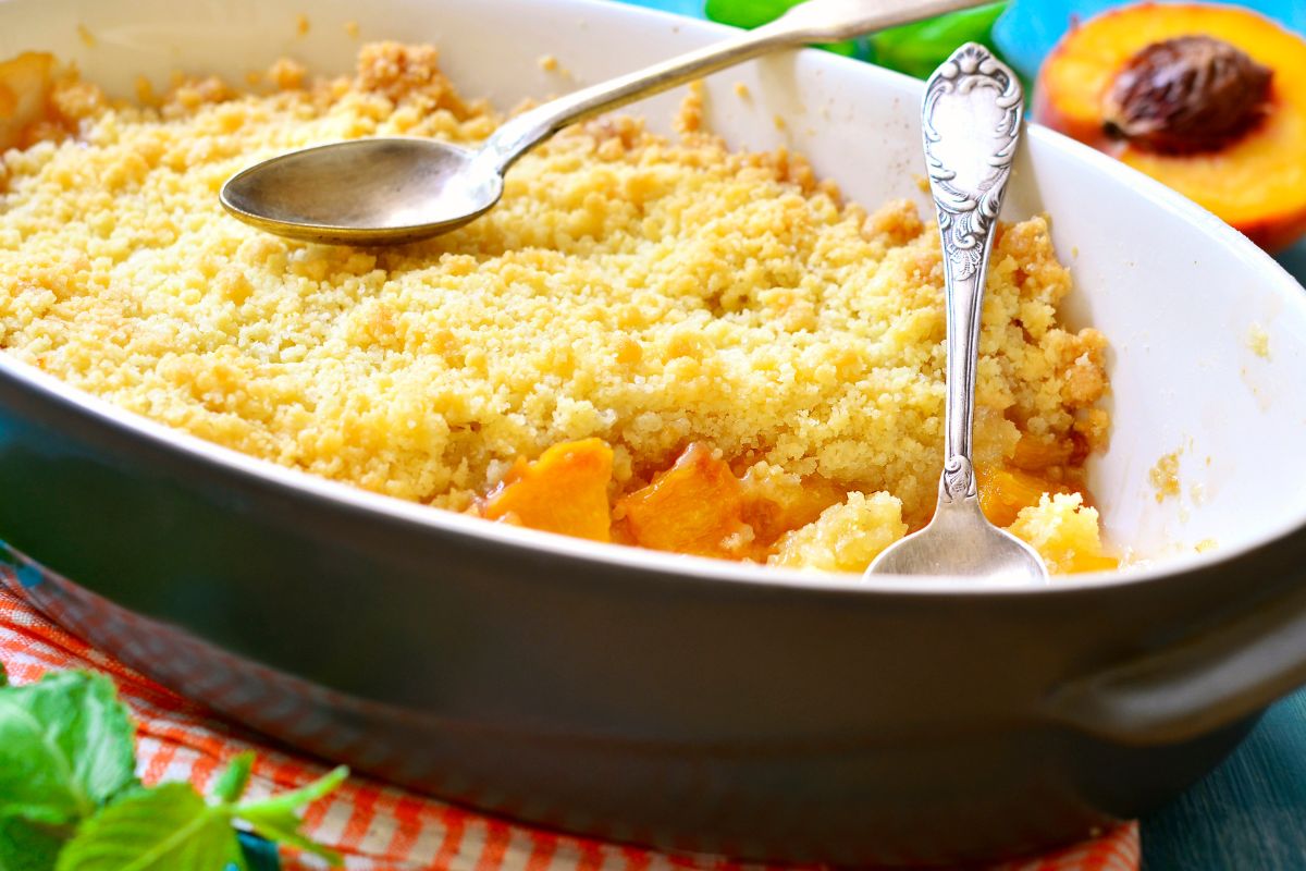 Peaches under crumble and fluffy custard will steal hearts