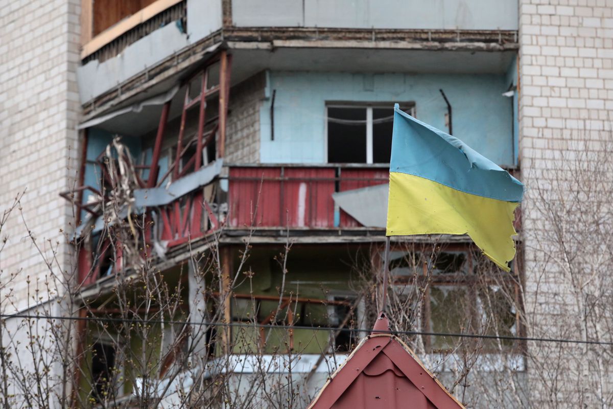 BORODIANKA, UKRAINE - APRIL 16, 2022 - A Ukrainian flag flies in front of an apartment building that was damaged as a result of shelling by Russian troops in Borodianka urban-type settlement that was liberated from Russian invaders, Kyiv Region, northern Ukraine.  (Photo by Hennadii Minchenko/Ukrinform/NurPhoto via Getty Images)