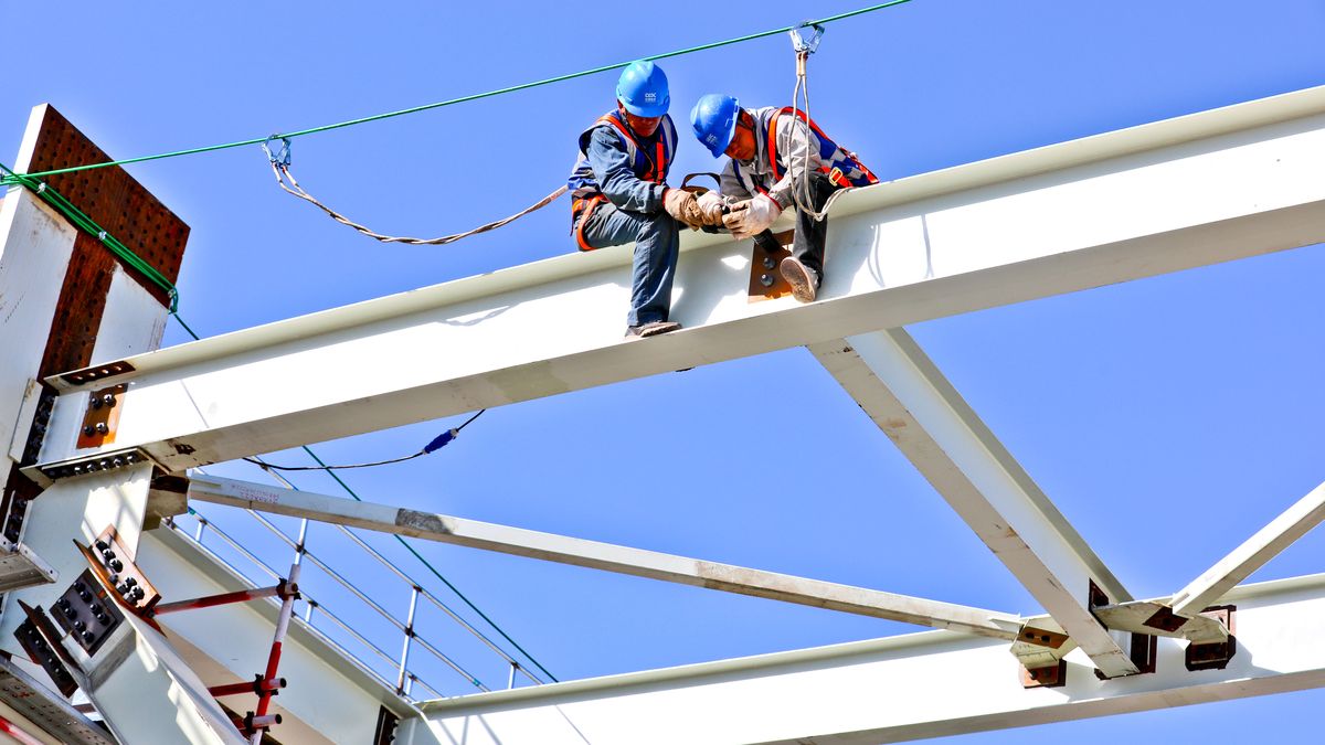 ZHANGYE, CHINA - SEPTEMBER 29, 2023 - Builders install a fixed steel roof truss at the construction site of the 21000MW coal-fired unit expansion project of the Power Investment Company Zhangye Power Plant in Zhangye city, Gansu province, China, Sept. 29, 2023. (Photo by Costfoto/NurPhoto via Getty Images)